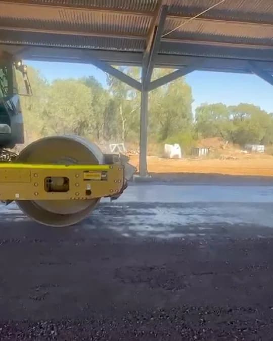 A water cart lightly watering a bound gate approach