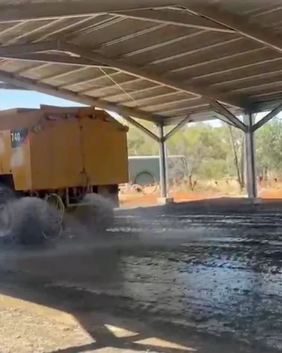 A loader working a stockpile on a firm, bound apron